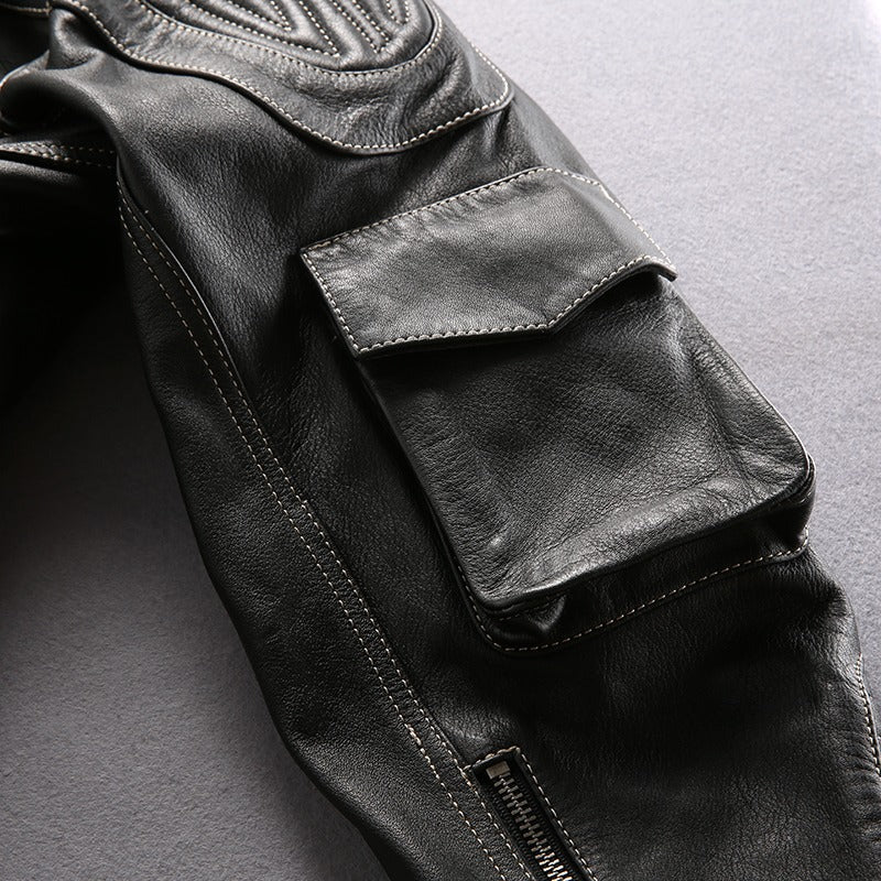 Close-up of stylish multi-pocket genuine leather motorcycle jacket showing textured fabric and detailed stitching.