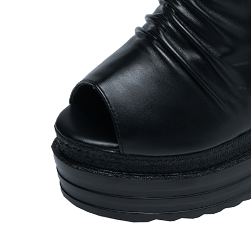Close-up of stylish black open-toe ankle boots for women featuring a comfortable wedge design.