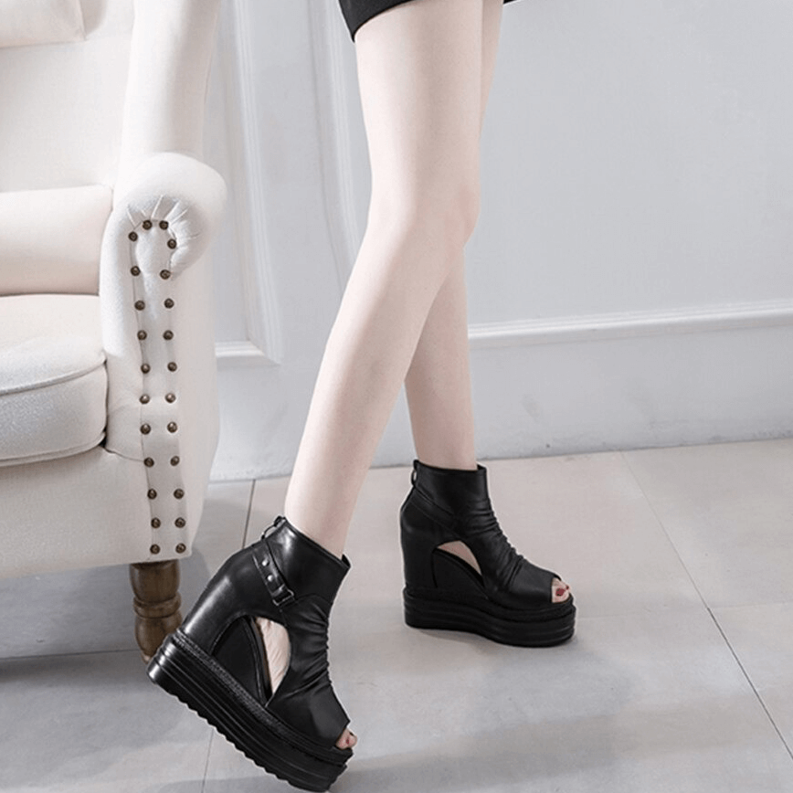 Stylish black open-toe ankle boots with wedge heel, perfect for casual outfits and trendy looks.