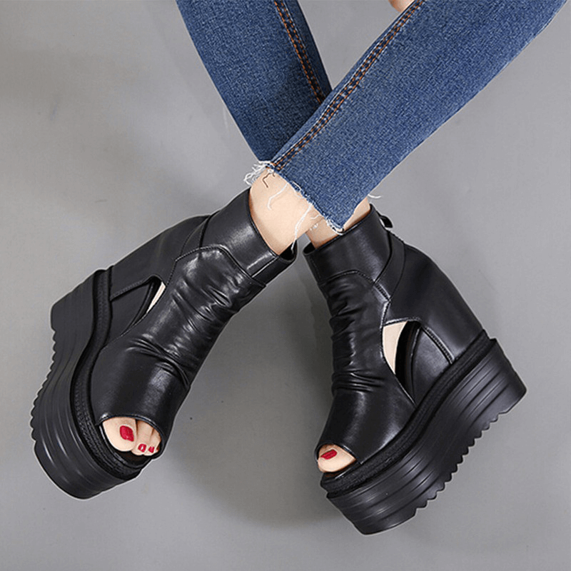 Stylish women's black open-toe ankle boots with wedges, perfect for casual outfits and fashionable looks.