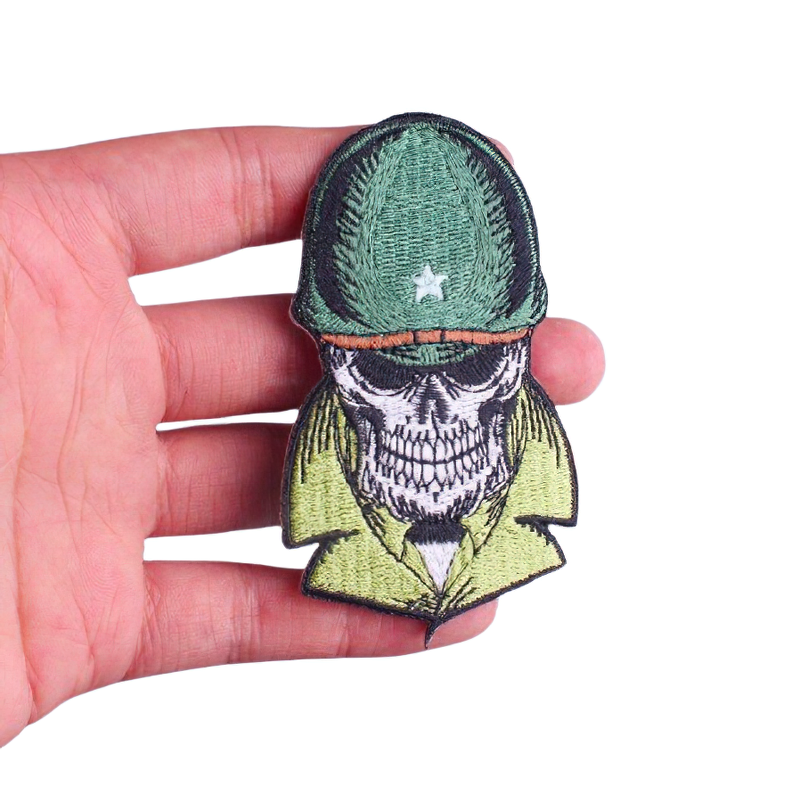 Unisex Military Skull In Helmet Patch being held in hand, stylish alternative fashion accessory for clothing.