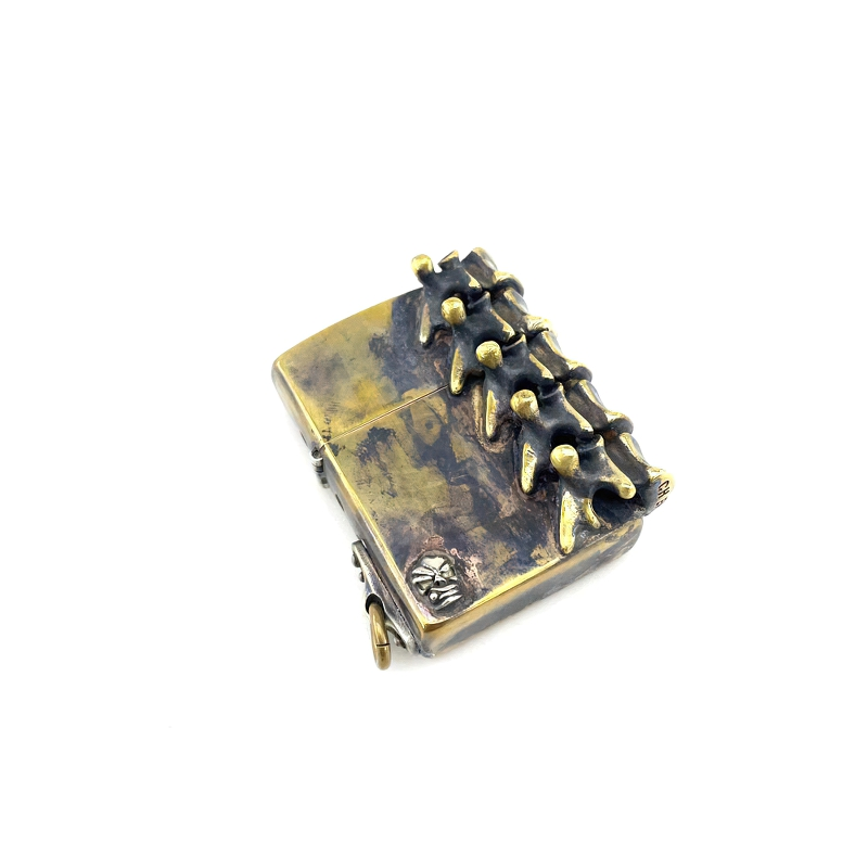 Stylish rock-style brass lighter case with spine design, perfect unisex accessory for a unique look.