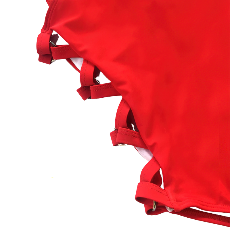 Close-up of stylish red monokini with hollow-out design and trendy buckle details for women.