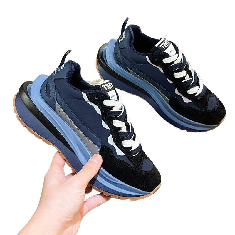 Stylish women's chunky sneakers in blue and black, showcasing mixed color design and trendy casual vibes.