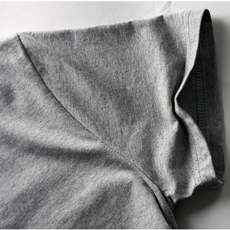 Close-up of the V neck and short sleeve design of a stylish gray T-shirt for men, showcasing its soft stretch fabric.
