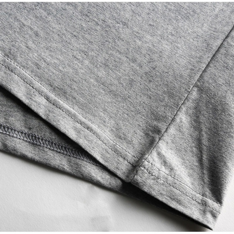 Close-up of the hem and sleeve of a stylish grey V neck stretch T-shirt for men, highlighting soft fabric and neat stitching.