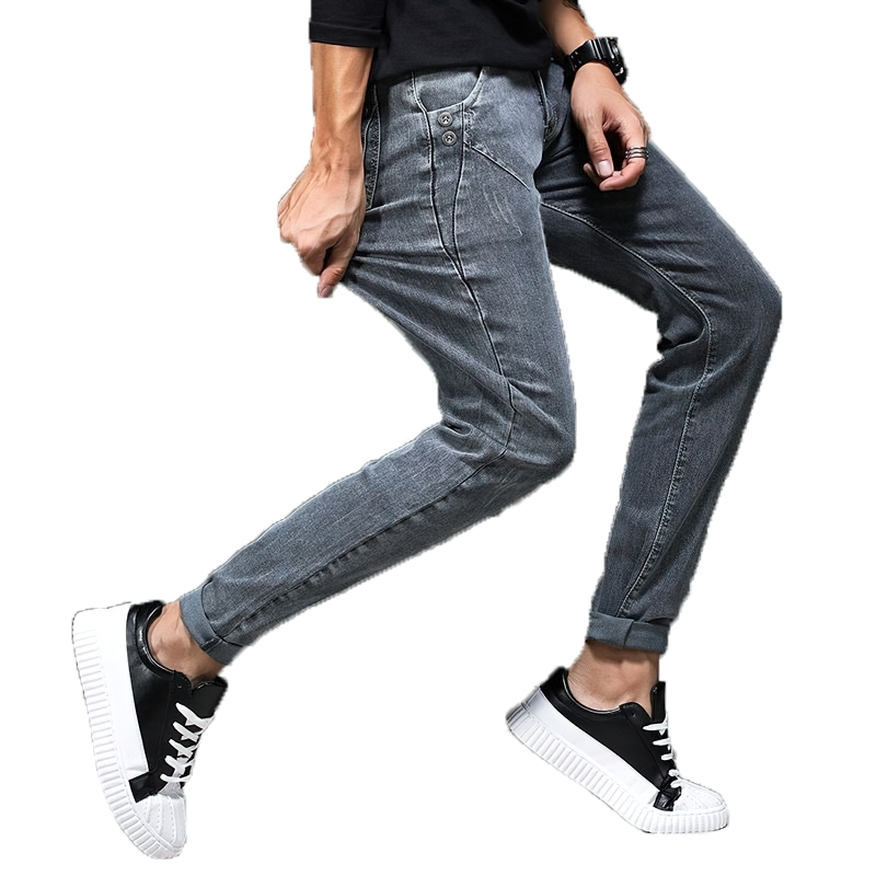 Stylish slim fit grey jeans for men, perfect for casual wear, paired with trendy black sneakers.