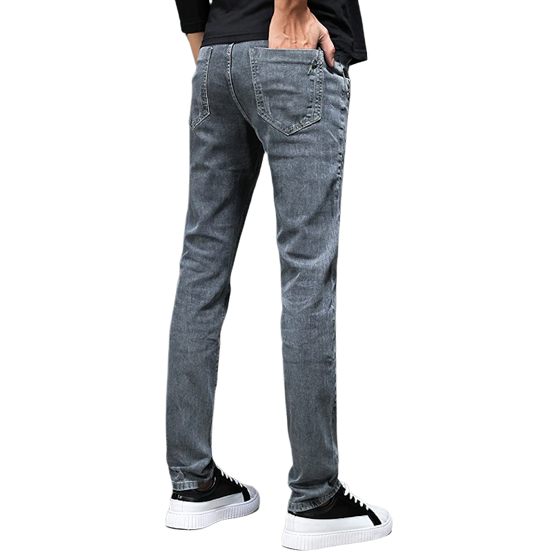 Stylish slim fit grey jeans for men, showcasing a casual look with trendy white sneakers.