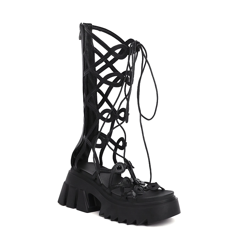 Stylish black gladiator sandals with thick soles and intricate lace-up cross straps for women.