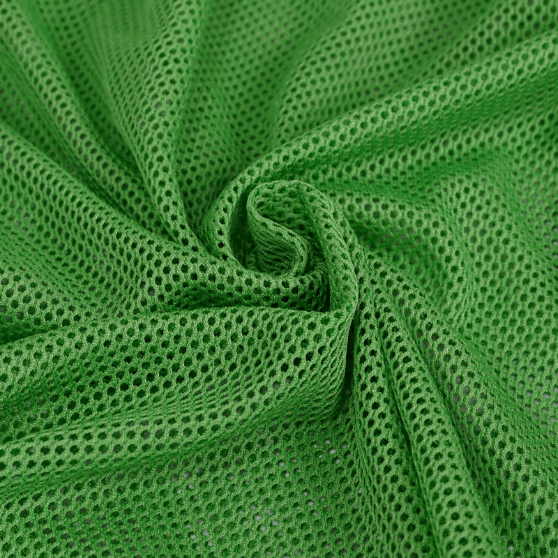 Close-up of soft green mesh fabric showcasing its breathable texture for stylish women's clothing.
