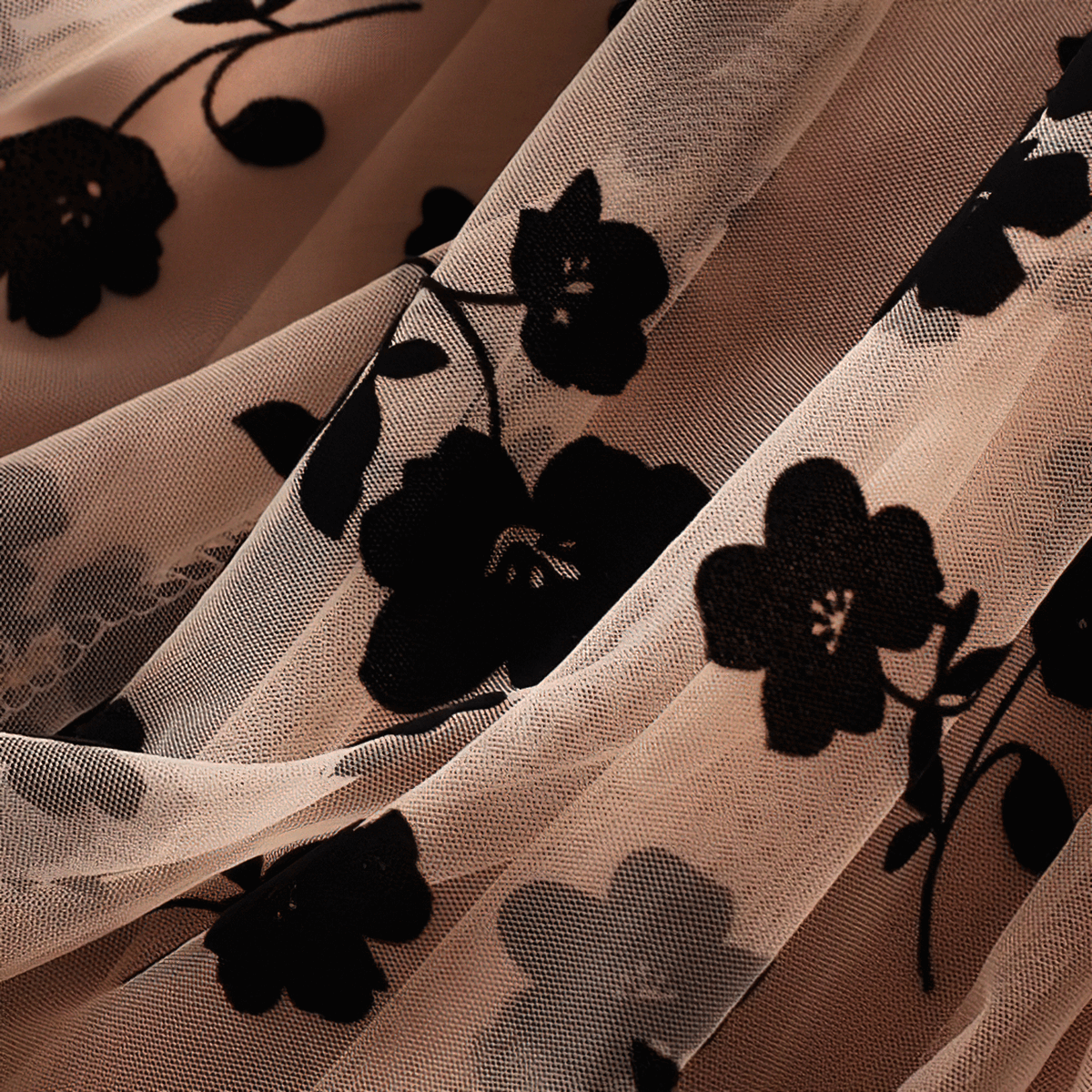 Elegant mesh tulle fabric featuring black embroidered flowers, perfect for a stylish women's high waist skirt.