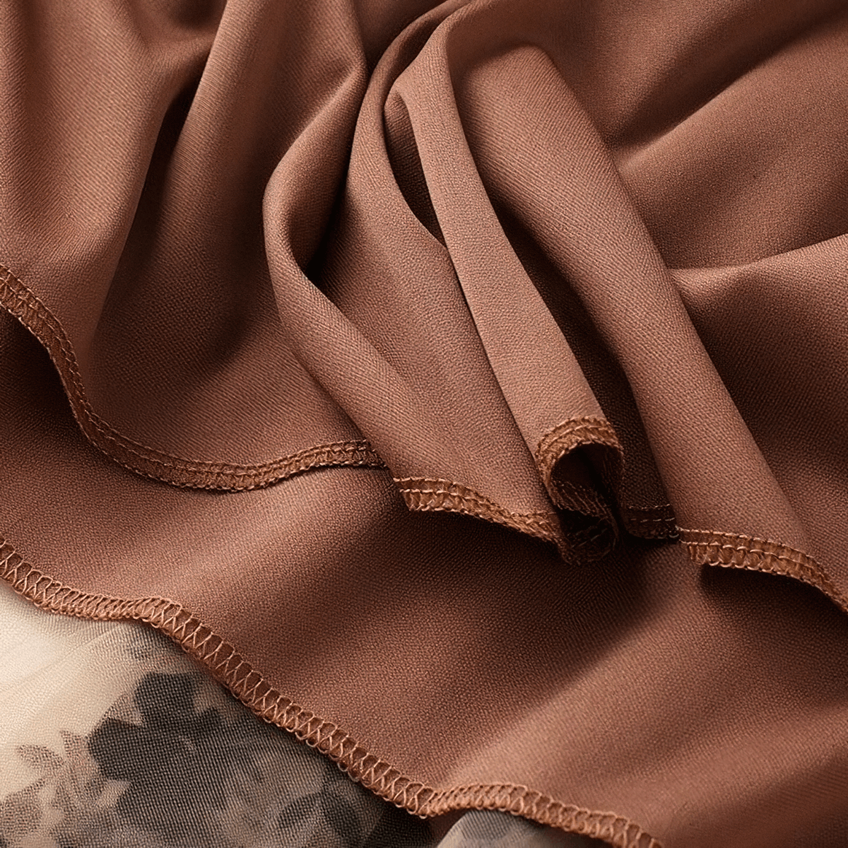 Close-up of soft brown fabric with delicate stitching, perfect for stylish women's high waist skirt.
