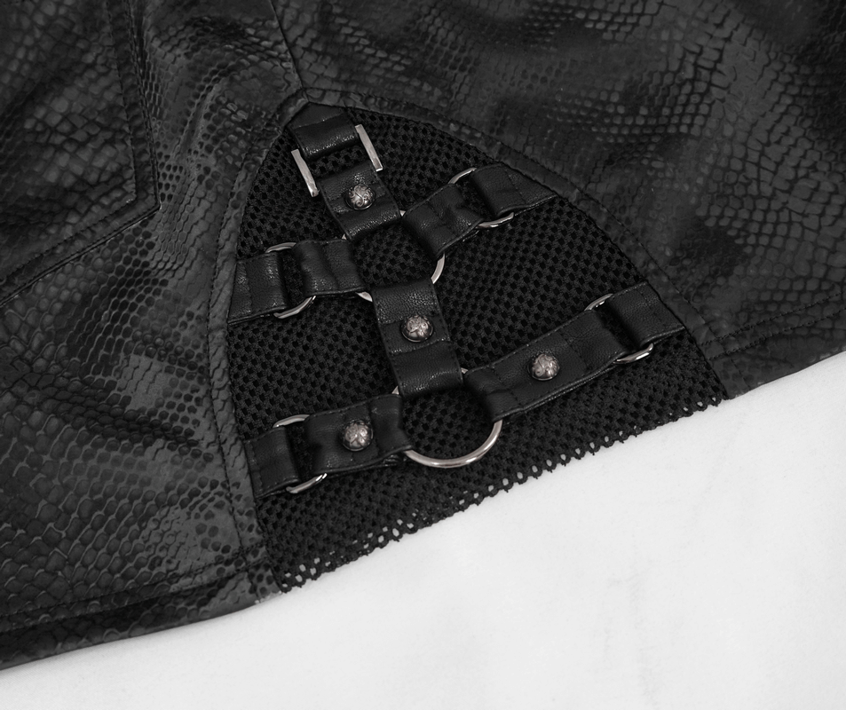 Close-up of stylish women's snakeskin mini skirt detailing with punk-inspired straps and mesh components.