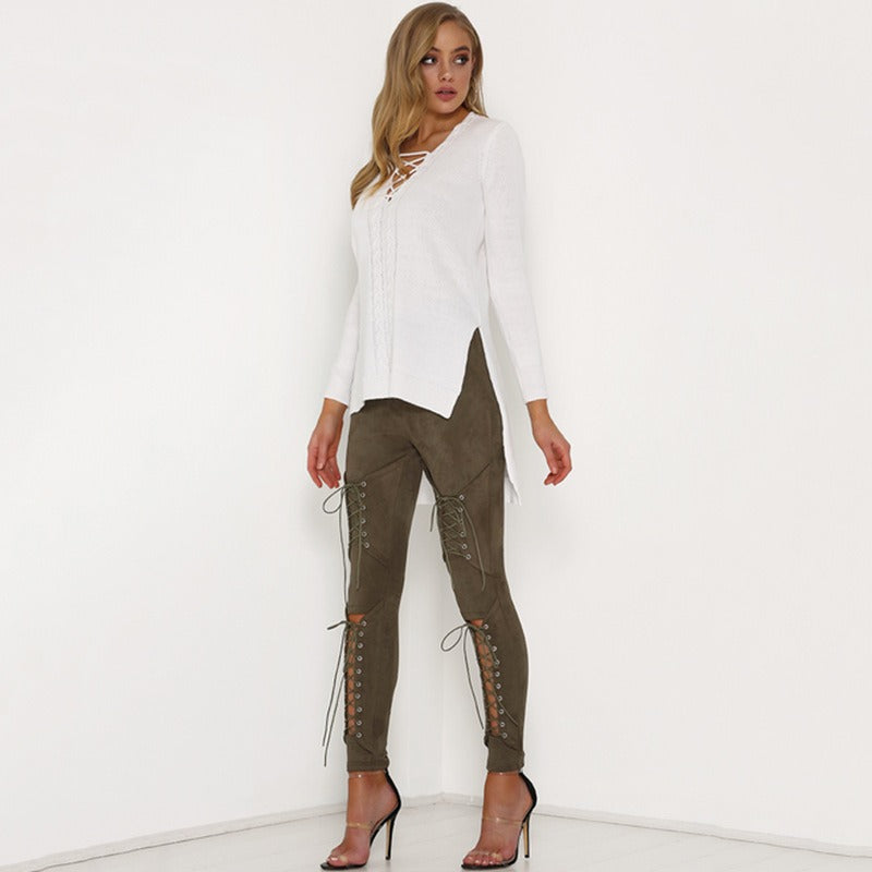 Women in olive suede bodycon bandage trousers with lace-up details, paired with a stylish white top and high heels.