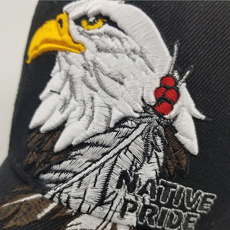 Close-up of eagle embroidery on a cap featuring 'Native Pride' text, perfect summer accessory for all.