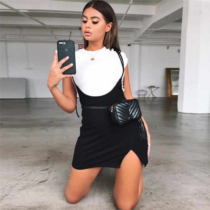 Model wearing a black summer skirt with shoulder straps and a white top, showcasing alternative fashion style.