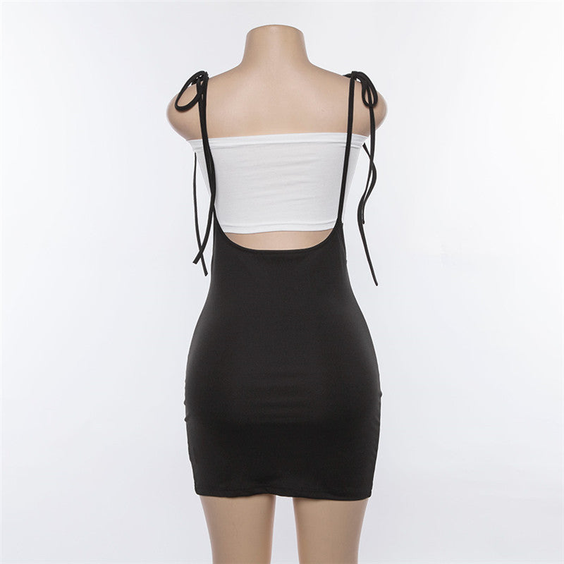 Back view of women's summer black skirt with shoulder straps, showcasing alternative fashion style.