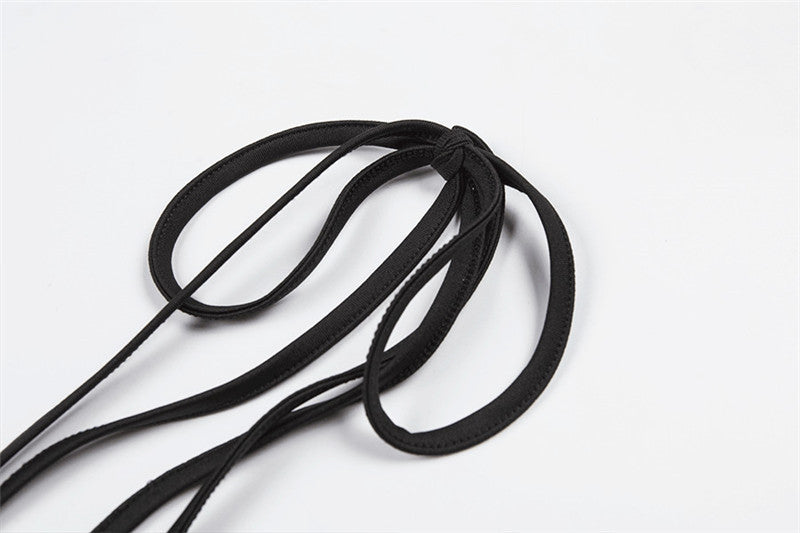 Close-up of black shoulder straps for a summer skirt, showcasing an alternative fashion style.