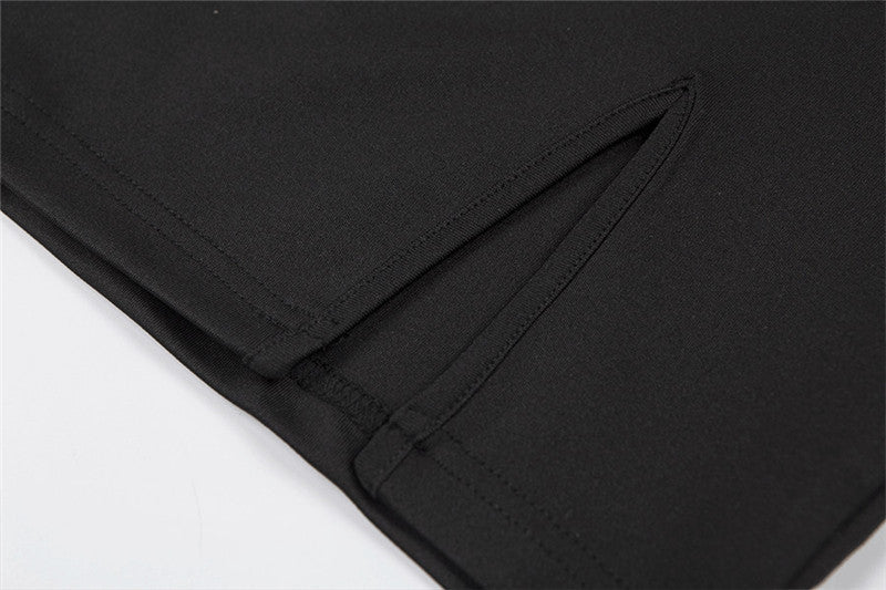 Close-up of a women's summer black skirt with side split and shoulder straps, featuring a sleek and stylish design.