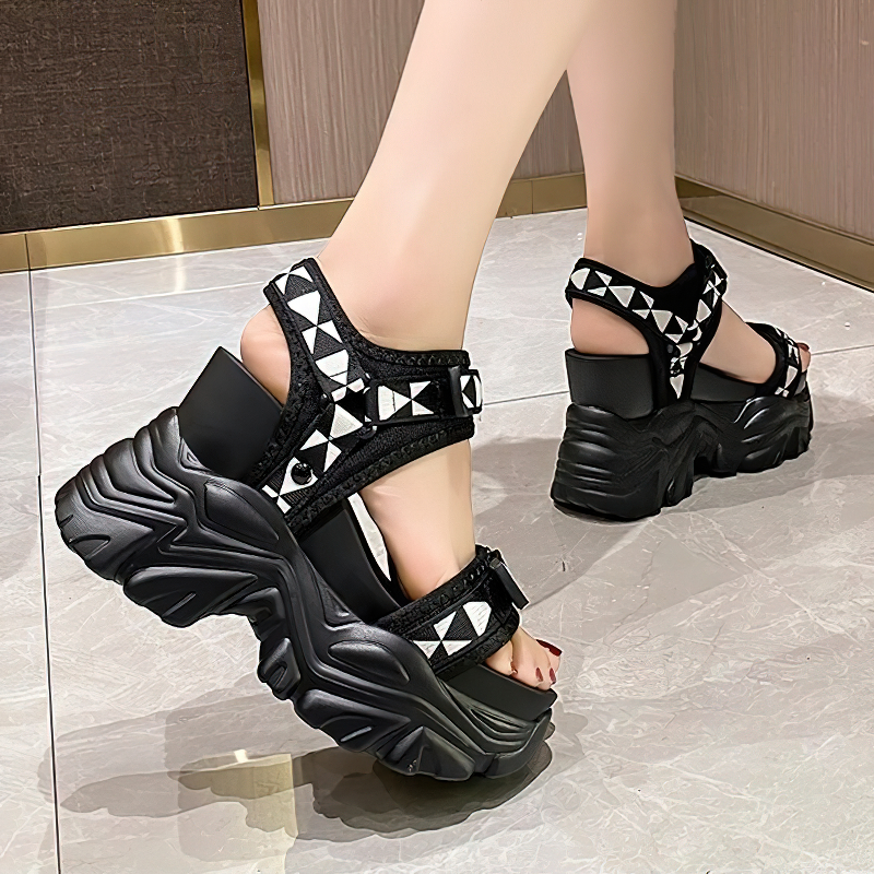 Stylish black super high platform sandals for ladies featuring edgy studded design, perfect for alternative fashion looks.