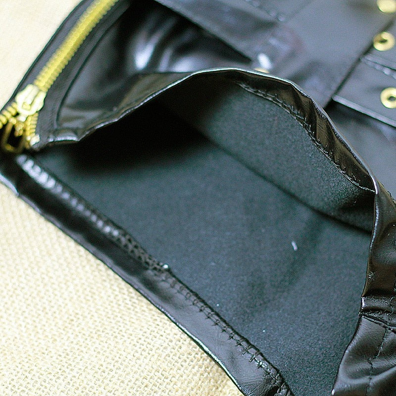 Interior view of black faux leather shorts showing zipper and smooth lining for comfort and style.