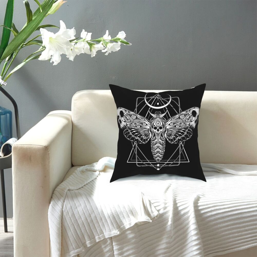 Surreal black moth cushion with intricate skull design, perfect for gothic home decor and stylish seating arrangements.