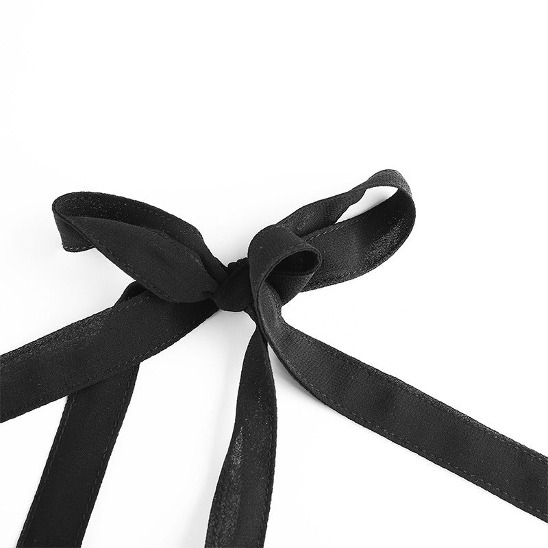 Close-up of a stylish black bow tie, perfect for gothic fashion accents on dresses.