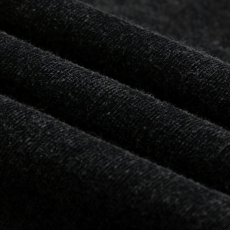 Close-up of soft black fabric showcasing the texture of a gothic style ripped tank top.