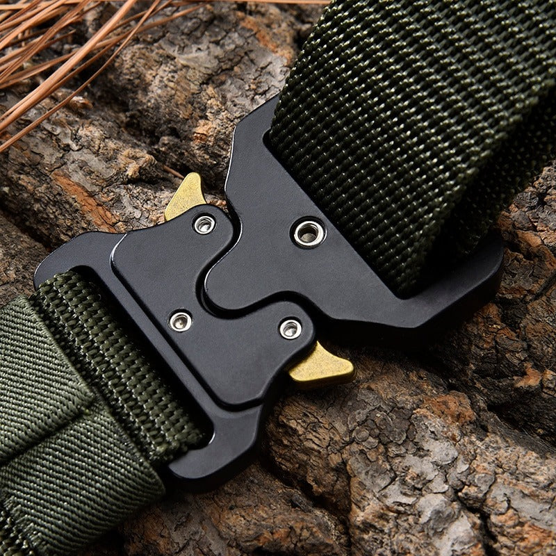 Close-up of tactical nylon belt with metal multifunctional buckle on tree bark background.