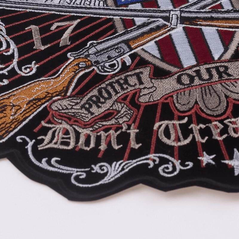 Embroidered iron-on patch featuring guns and 2nd Amendment theme for jackets and biker apparel.