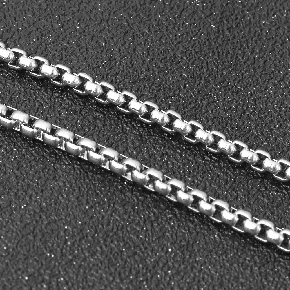 Close-up of a sleek titanium stainless steel chain necklace, perfect for alternative fashion and zodiac jewelry.