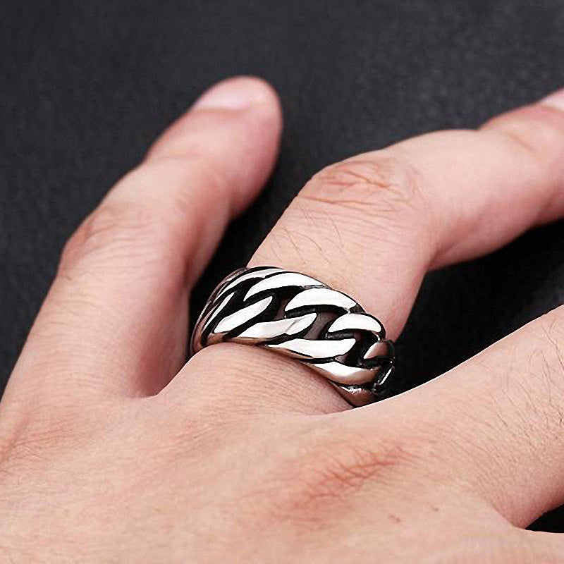 Stylish titanium steel biker chain ring worn on a finger, showcasing its shiny stainless steel design and bold chain pattern.