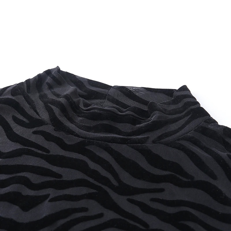 Close-up of a transparent long sleeve bodysuit featuring stylish black tiger stripes for women's fashion.