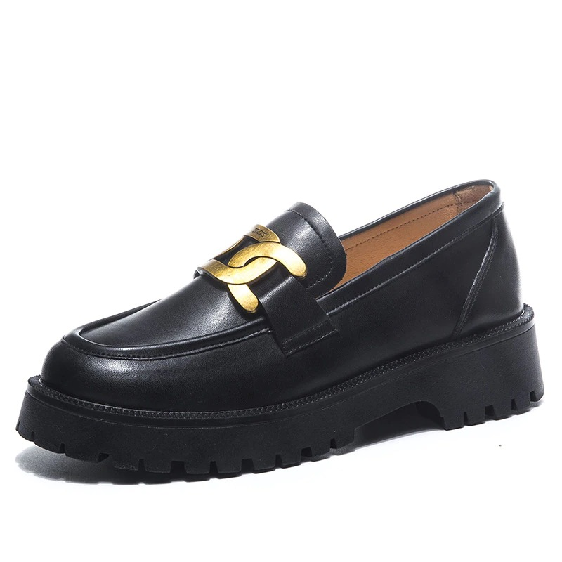 Trendy thick-soled black leather loafers for women with gold chain detail, perfect for casual outfits.