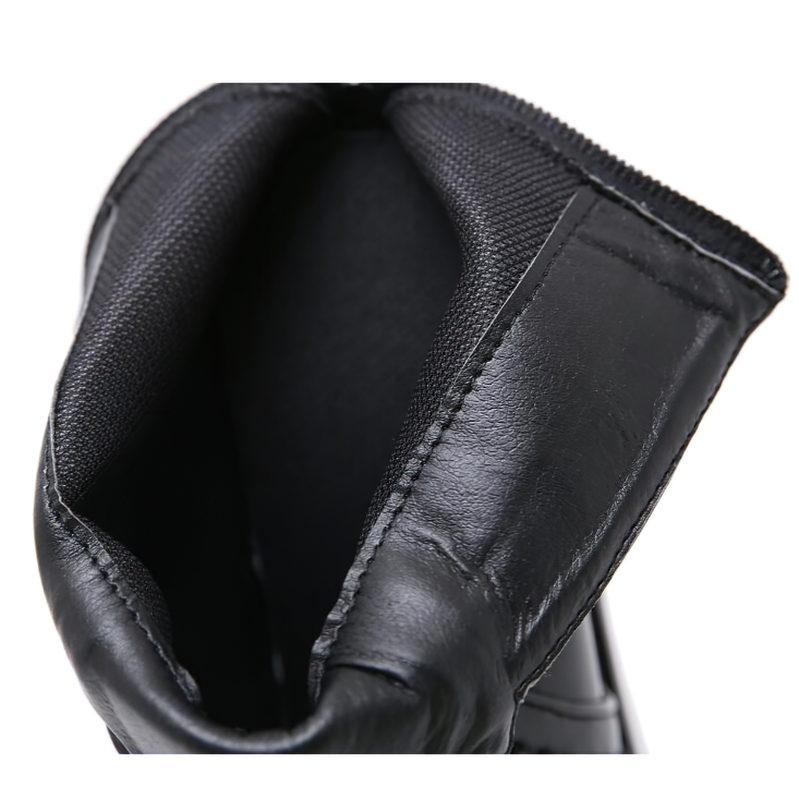 Close-up view of the interior of trendy black autumn boots showcasing leather and fabric details.