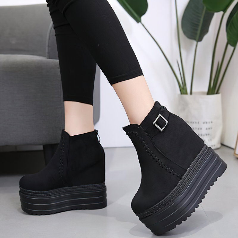 Trendy black high platform ankle boots with zipper and buckle detail, perfect for casual autumn outfits.
