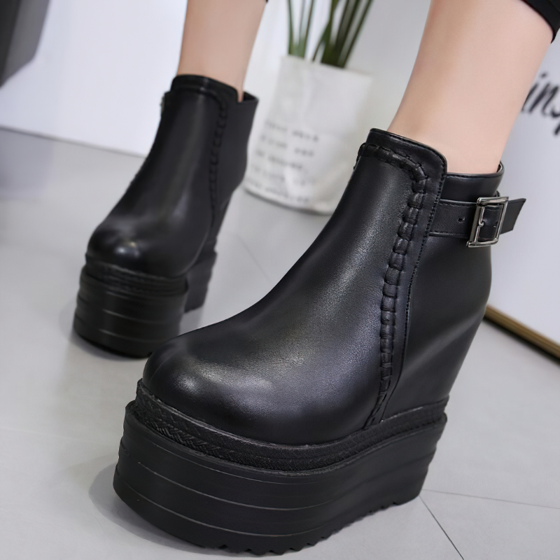 Trendy autumn black boots on a high platform with zipper and ankle buckle, perfect for casual women's fashion.