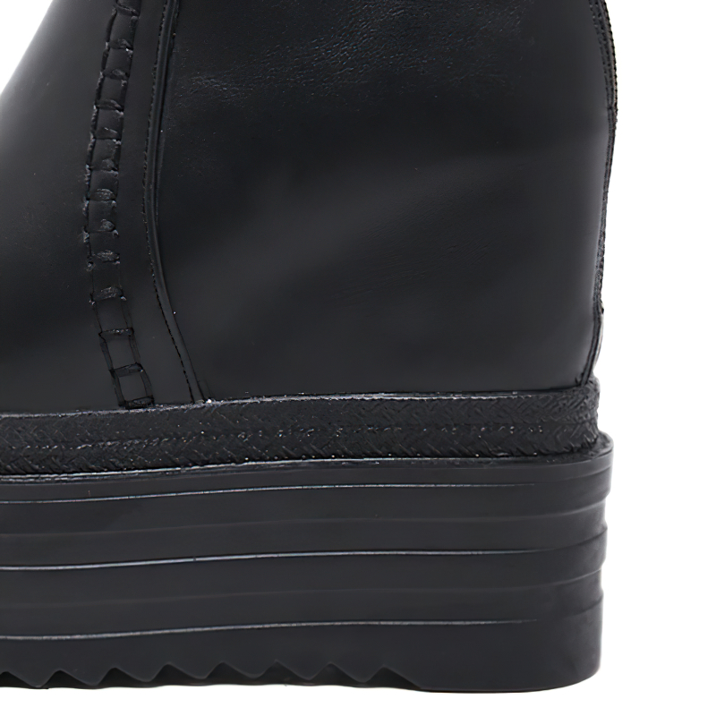 Side view of trendy black high platform boots with sleek leather finish and stylish stitching for women's casual wear.