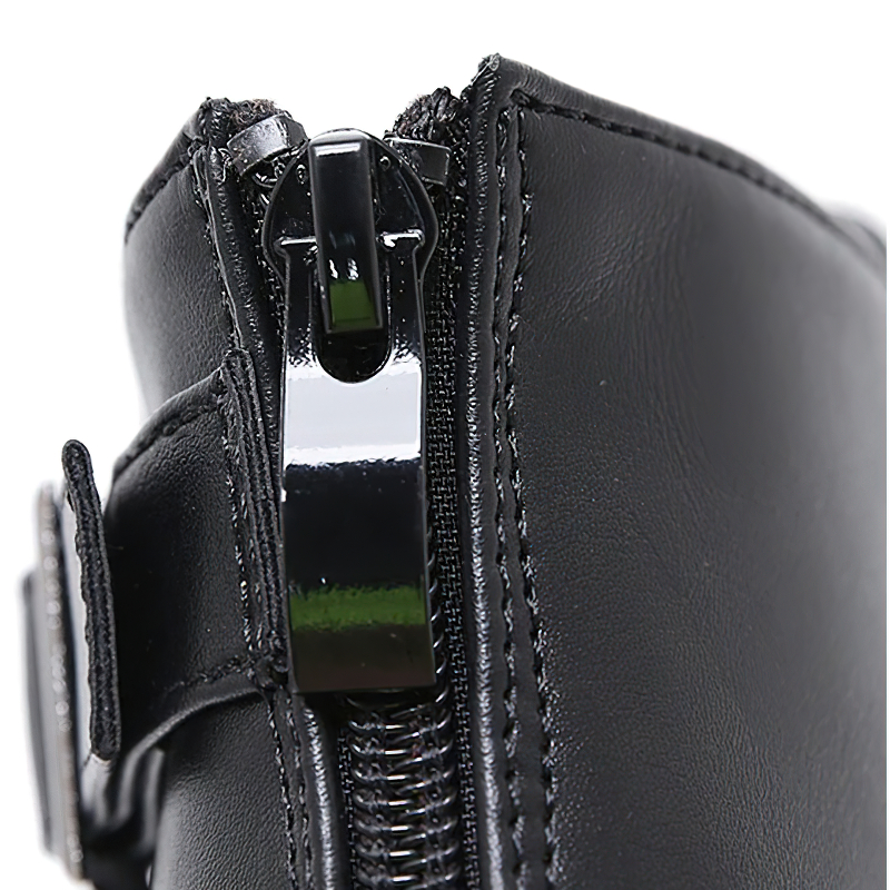 Close-up of trendy autumn black boots with zipper and ankle buckle detail for casual women's style.