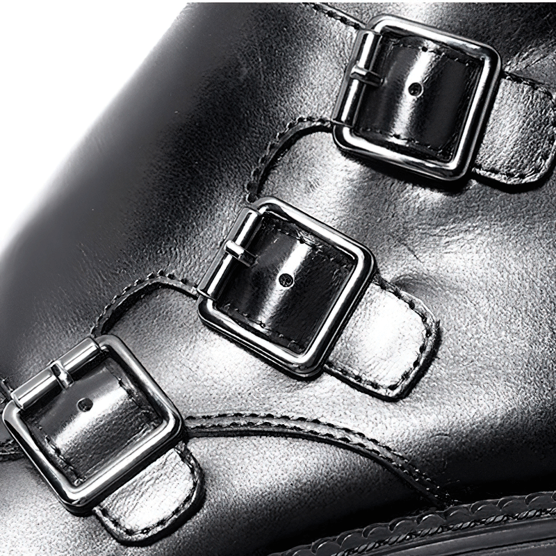 Close-up of trendy black ankle boots featuring stylish buckles for a modern casual look.