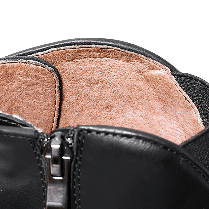 Close-up of trendy men's ankle boots showing the smooth leather lining and stylish zipper detail.