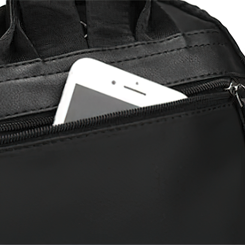 Close-up of a woman's black backpack zipper with a phone inside for convenient access.