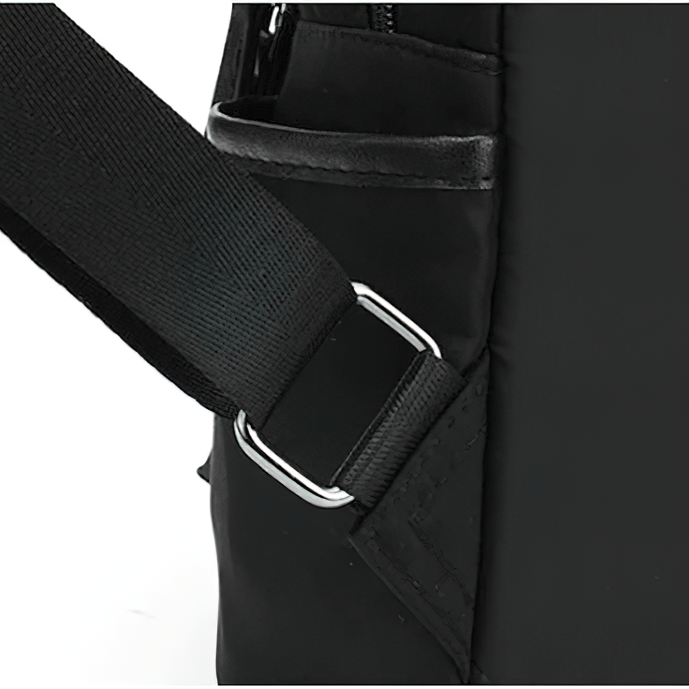 Close-up of trendy black women's casual Oxford cloth backpack strap and pocket details.