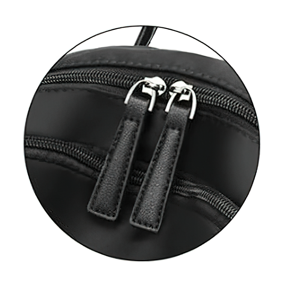 Close-up of the stylish zippers on a trendy black Oxford cloth backpack for women.