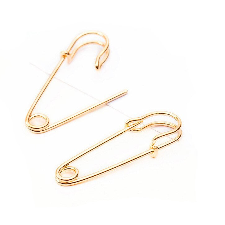 Gold punk rock safety pin earrings, unisex alternative jewelry for a trendy look.