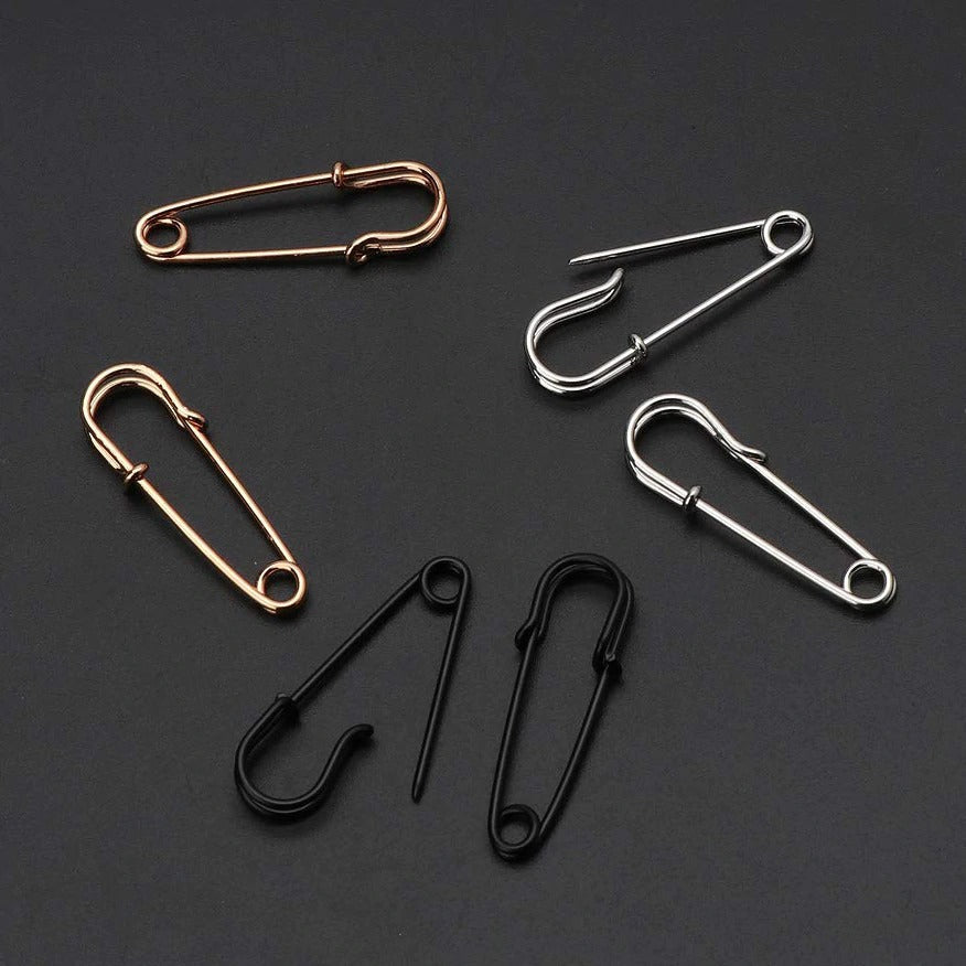 A collection of trendy unisex punk rock safety pin earrings in gold, silver, and black metal styles, perfect for alternative fashion.