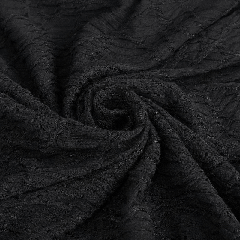 Black textured fabric close-up, showcasing elegant draping and intricate detailing for stylish apparel.