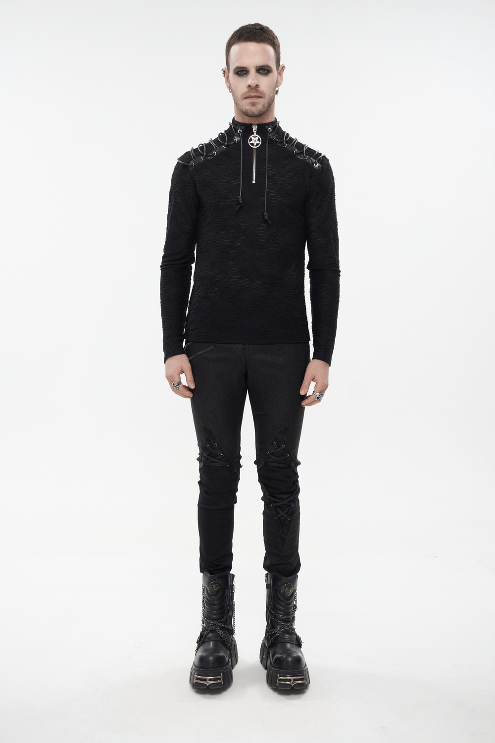 Men's turtleneck sweatshirt with lacing on shoulders, sporty punk style, paired with black pants and chunky boots.