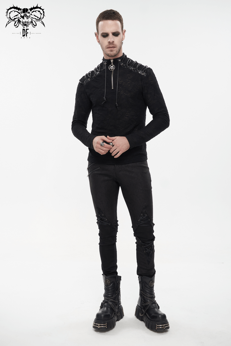 Men's black turtleneck sweatshirt with shoulder lacing, paired with edgy black pants and chunky boots.