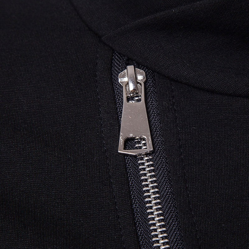 Close-up of a sleek silver zipper on a black turtleneck sweater with PU leather sleeves.
